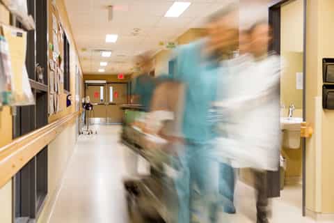 Rushing_Gurney_Down_Hospital_Hallway_Emergency_Depositphotos_480x320_Q50 Rushing Gurney Down Hospital Hallway Emergency De[t
